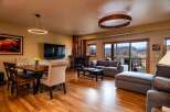 Experience luxury living in this stunning property, featuring a cozy fireplace and a modern entertainment setup.
