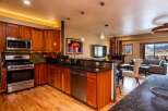 This stunning kitchen boasts beautiful wooden cabinetry, stainless steel appliances, and sleek granite countertops, creating a warm and inviting atmosphere.