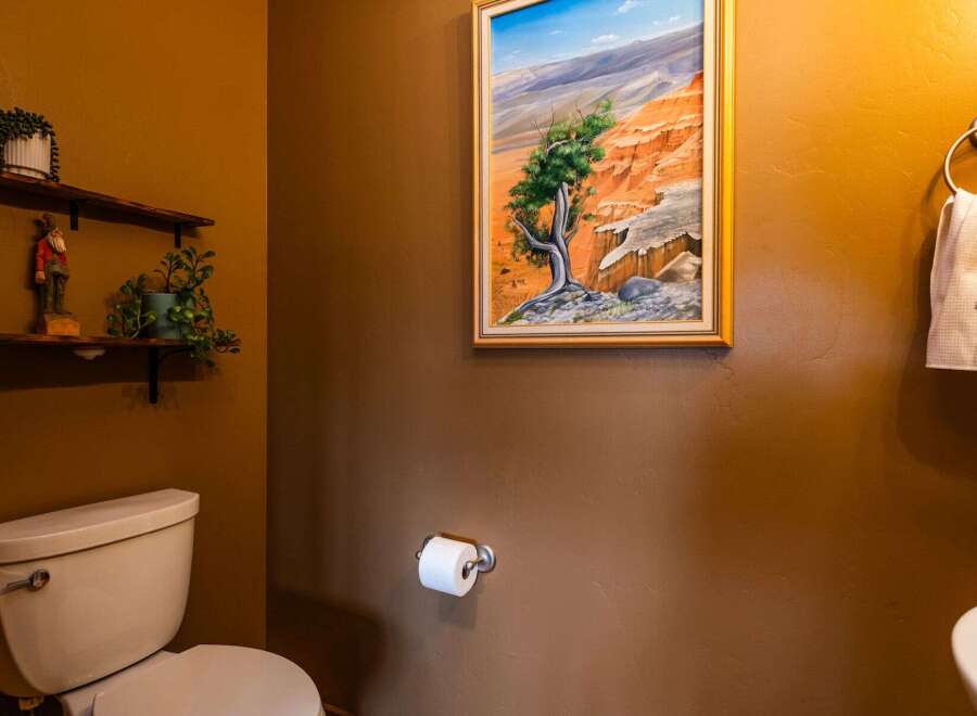 This charming bathroom features a unique blend of rustic and artistic elements.