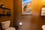This charming bathroom features a unique blend of rustic and artistic elements.