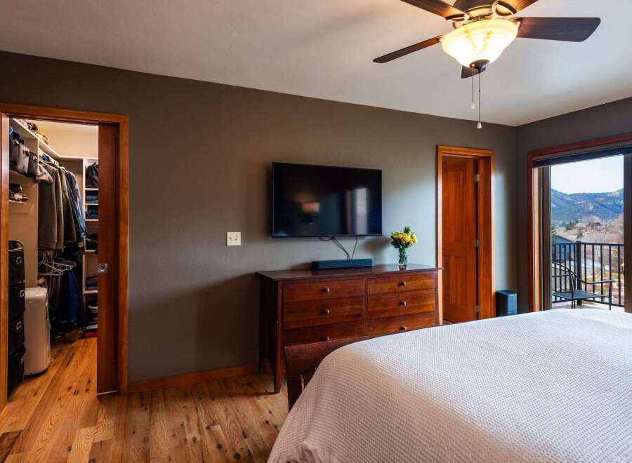 Step into a beautifully designed bedroom featuring a spacious walk-in closet, perfect for organizing your wardrobe.