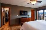 Step into a beautifully designed bedroom featuring a spacious walk-in closet, perfect for organizing your wardrobe.
