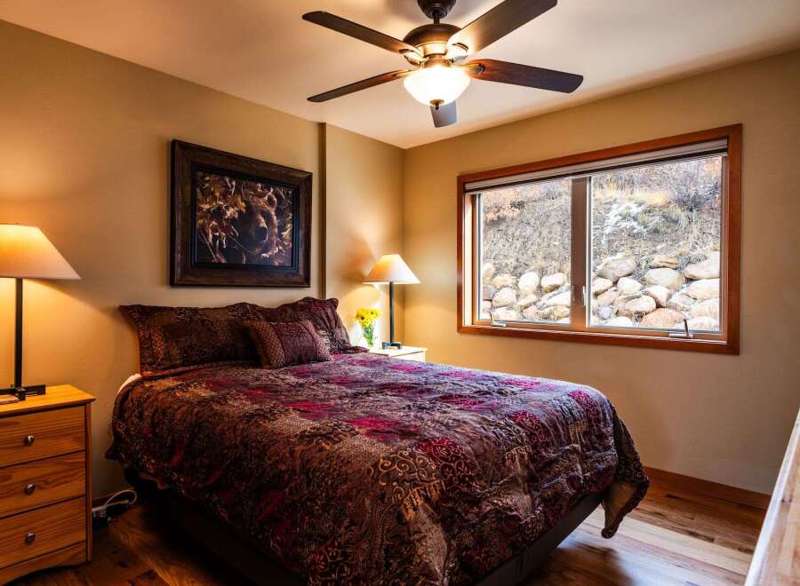 This cozy bedroom features a comfortable bed with a patterned comforter, perfect for a relaxing retreat.