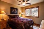 This cozy bedroom features a comfortable bed with a patterned comforter, perfect for a relaxing retreat.
