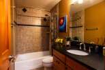 This stunning bathroom boasts a modern design with a touch of warmth.