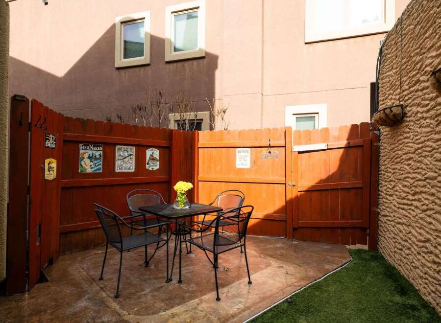 Enjoy outdoor living in this charming patio space! Featuring a cozy seating area with a table and chairs, perfect for relaxing or entertaining.