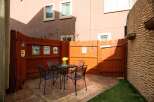 Enjoy outdoor living in this charming patio space! Featuring a cozy seating area with a table and chairs, perfect for relaxing or entertaining.