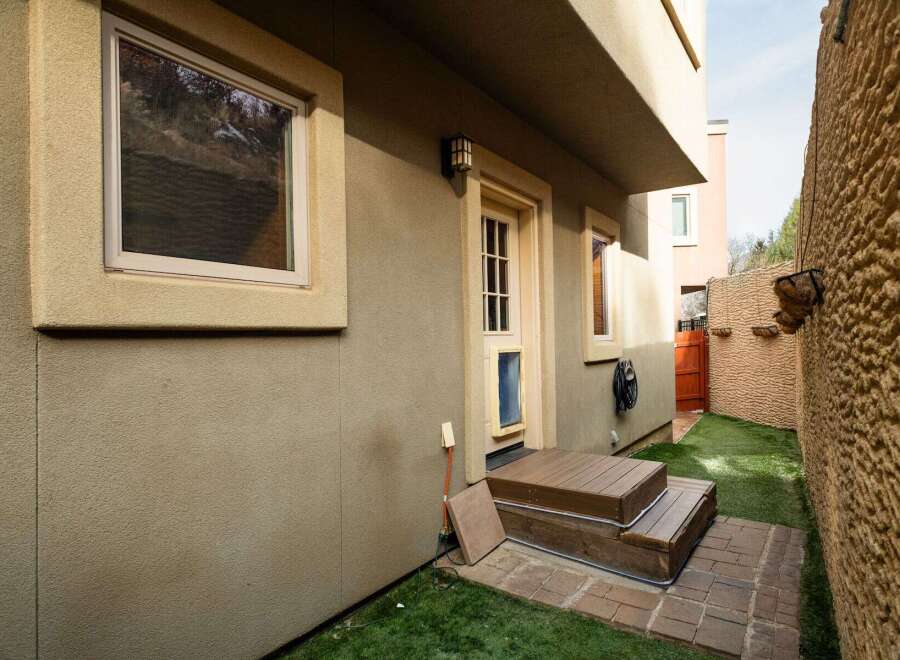 Discover the charm of this property, featuring a welcoming entrance with a wooden deck and steps.