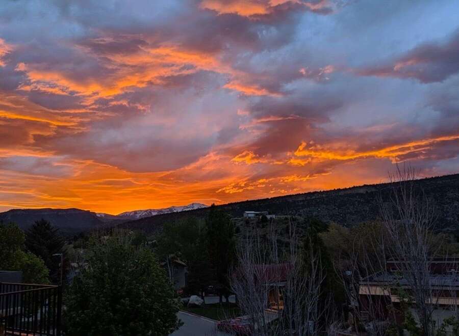 Enjoy breathtaking sunsets from this stunning property! This home offers panoramic views of the mountains and vibrant skies.