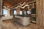 Experience luxury living in this stunning chalet, featuring a custom-built bar perfect for entertaining.