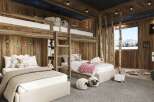 This cozy bedroom features a unique bunk bed design with wooden accents, creating a warm and inviting atmosphere.