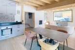 This stunning property boasts a modern kitchen with sleek cabinetry and a stylish dining area.