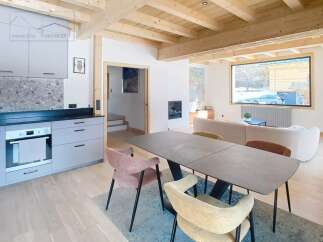This stunning property boasts a modern kitchen with sleek cabinetry and a stylish dining area.