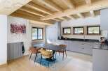 This stunning property boasts a modern kitchen with sleek gray cabinetry and a contrasting black countertop.