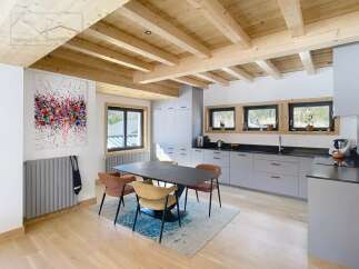 This stunning property boasts a modern kitchen with sleek gray cabinetry and a contrasting black countertop.