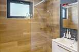 Step into this modern bathroom featuring a sleek shower with a glass enclosure and a stylish vanity.