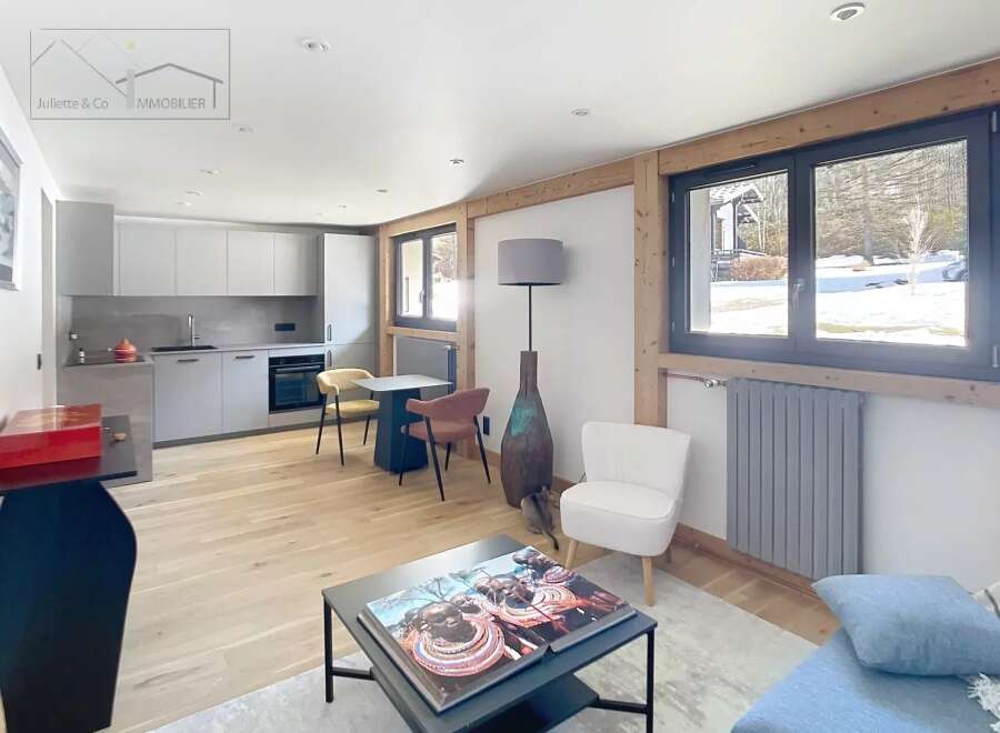 Discover modern living in this stunning property, featuring a sleek, open-plan kitchen and a cozy living area.
