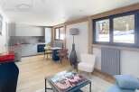 Discover modern living in this stunning property, featuring a sleek, open-plan kitchen and a cozy living area.