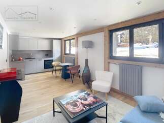 Discover modern living in this stunning property, featuring a sleek, open-plan kitchen and a cozy living area.