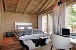 Experience luxury living in this stunning bedroom featuring a unique cowhide bathtub.