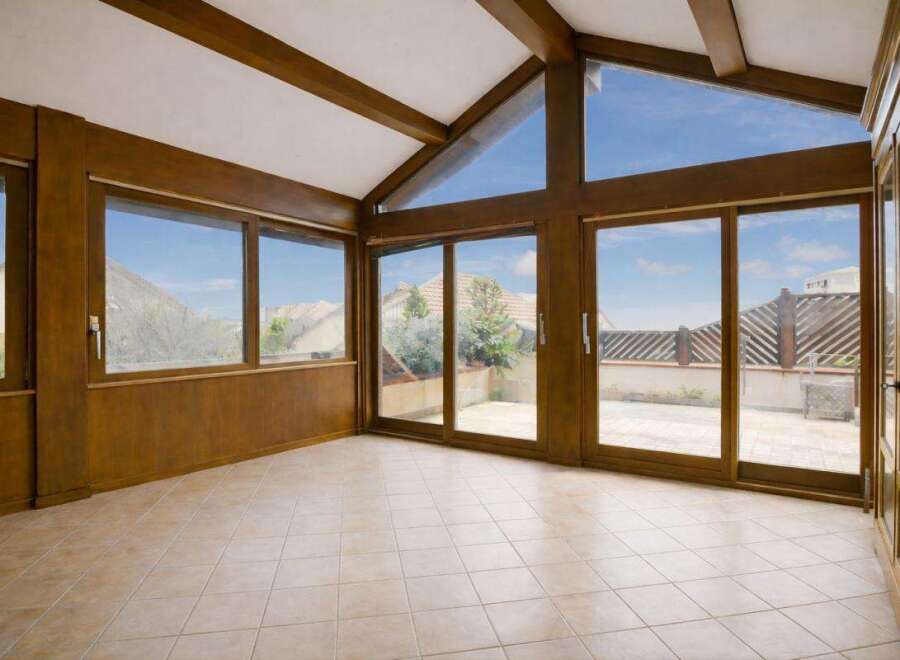 Step into this sun-drenched room with expansive windows that offer stunning views and flood the space with natural light.