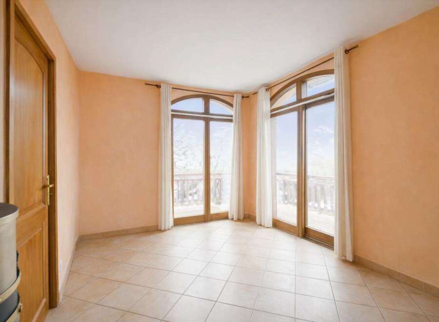 This stunning property boasts a bright and airy interior with large windows that offer breathtaking views.