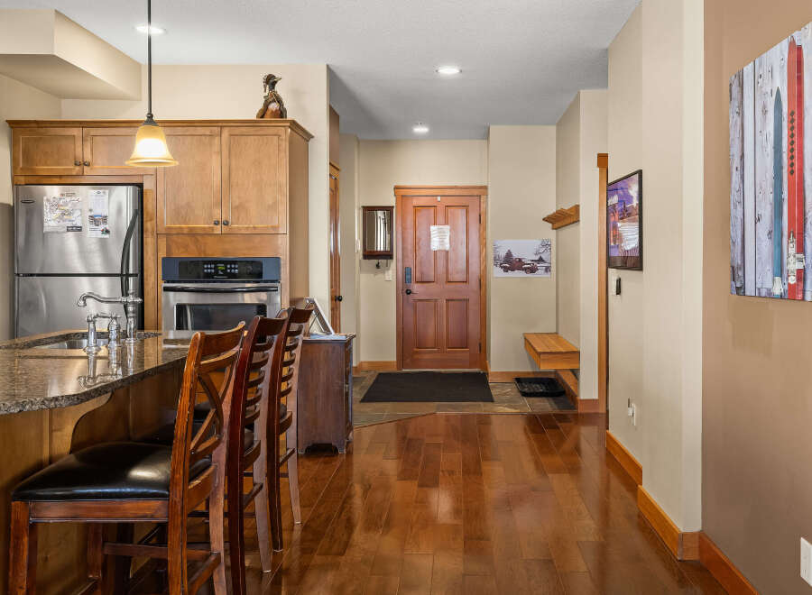 Step into this inviting kitchen and entryway, showcasing a seamless blend of style and functionality.