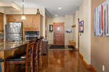 Step into this inviting kitchen and entryway, showcasing a seamless blend of style and functionality.
