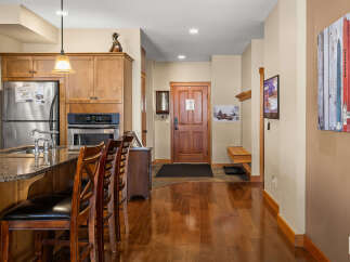 Step into this inviting kitchen and entryway, showcasing a seamless blend of style and functionality.