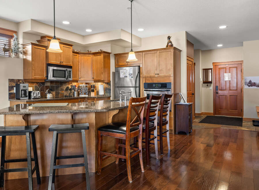 This stunning kitchen boasts beautiful wooden cabinetry and a spacious island, perfect for entertaining.