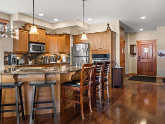 This stunning kitchen boasts beautiful wooden cabinetry and a spacious island, perfect for entertaining.
