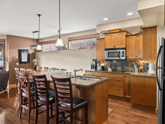 This stunning kitchen boasts a spacious island with seating, perfect for entertaining or casual dining.