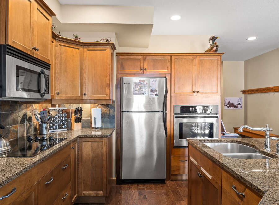 This stunning kitchen boasts custom cabinetry, stainless steel appliances, and granite countertops, creating a luxurious and functional space.