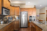 This stunning kitchen boasts custom cabinetry, stainless steel appliances, and granite countertops, creating a luxurious and functional space.