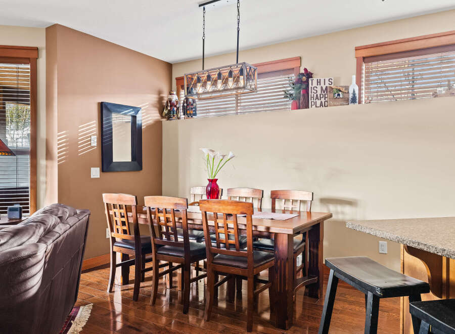 This inviting dining area features a beautiful wooden table and chairs, perfect for family gatherings.