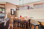 This inviting dining area features a beautiful wooden table and chairs, perfect for family gatherings.
