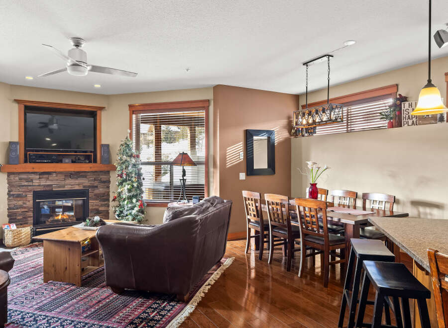 Step into this inviting living space, featuring a cozy fireplace and a stylish entertainment center.