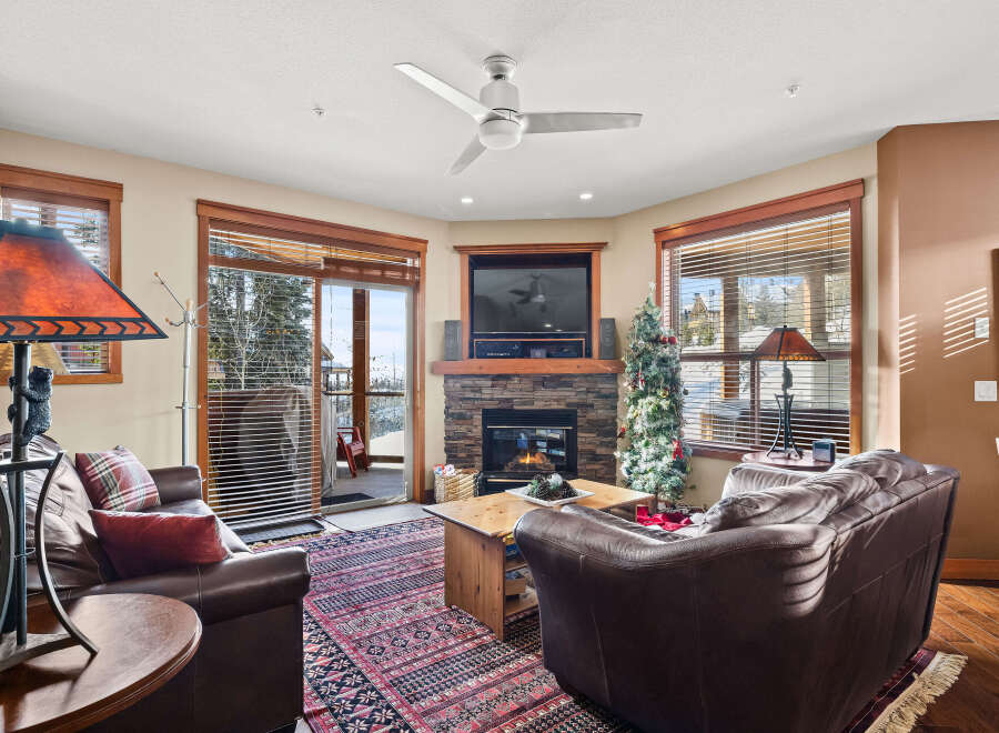Step into luxury with this stunning living room, featuring a cozy fireplace and elegant leather seating.