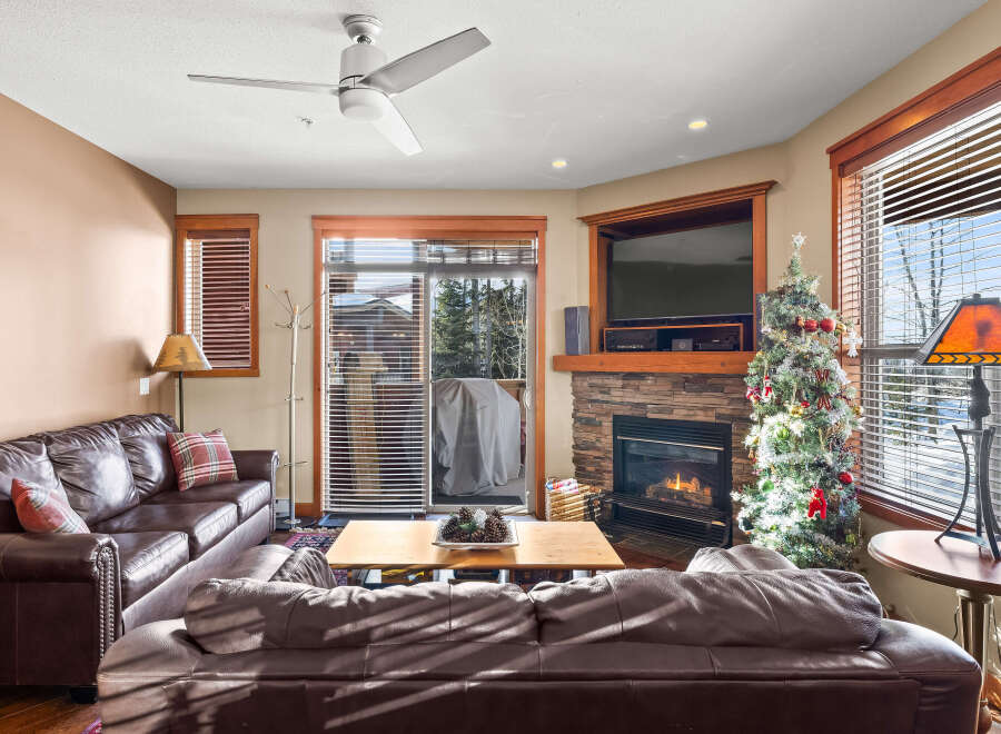 This cozy living room features a beautiful stone fireplace, perfect for those chilly evenings.