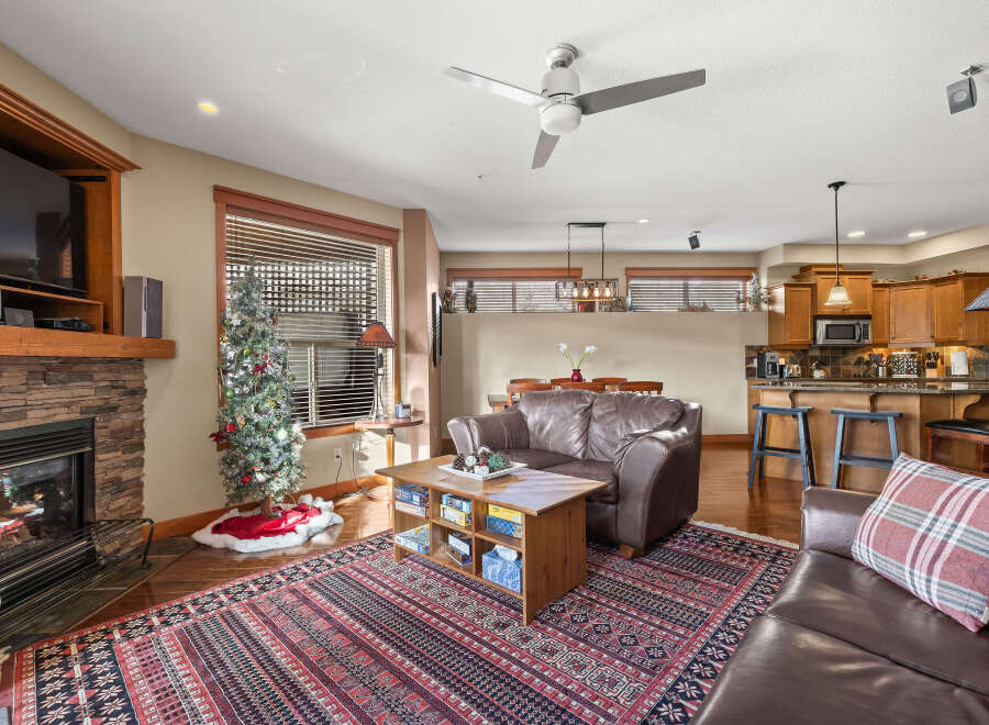 This stunning property boasts a cozy living room with a stone fireplace, perfect for those chilly evenings.