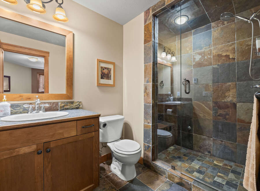 This stunning bathroom features a luxurious walk-in shower with beautiful stone tile, creating a spa-like atmosphere.