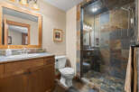 This stunning bathroom features a luxurious walk-in shower with beautiful stone tile, creating a spa-like atmosphere.