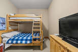 This cozy bedroom features a charming bunk bed, perfect for accommodating guests or family members.