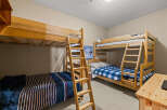 This cozy bedroom features two sets of bunk beds, perfect for accommodating multiple guests or family members.