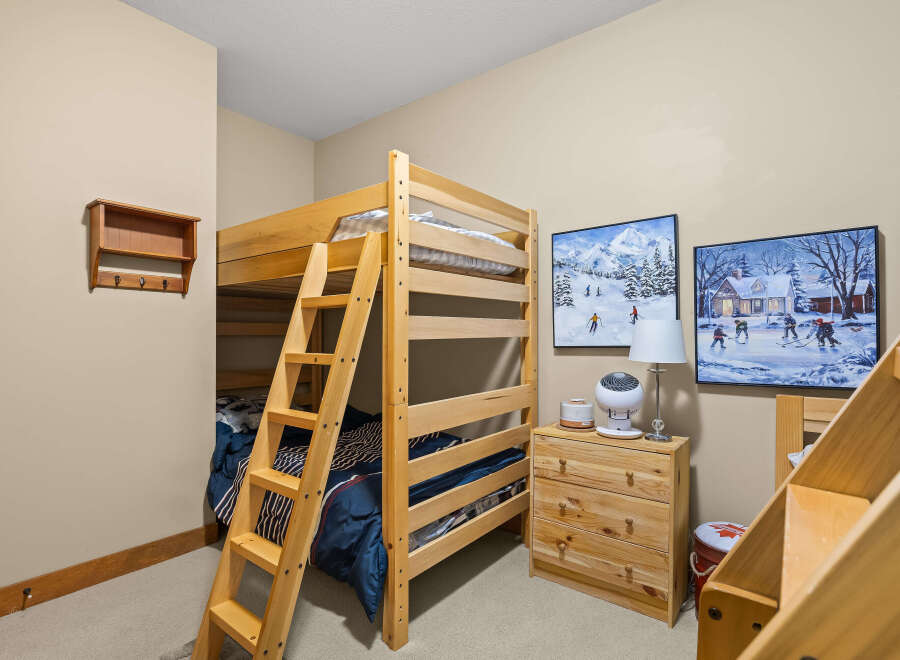 This charming bedroom features a cozy bunk bed, perfect for kids or guests.