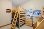 This charming bedroom features a cozy bunk bed, perfect for kids or guests.