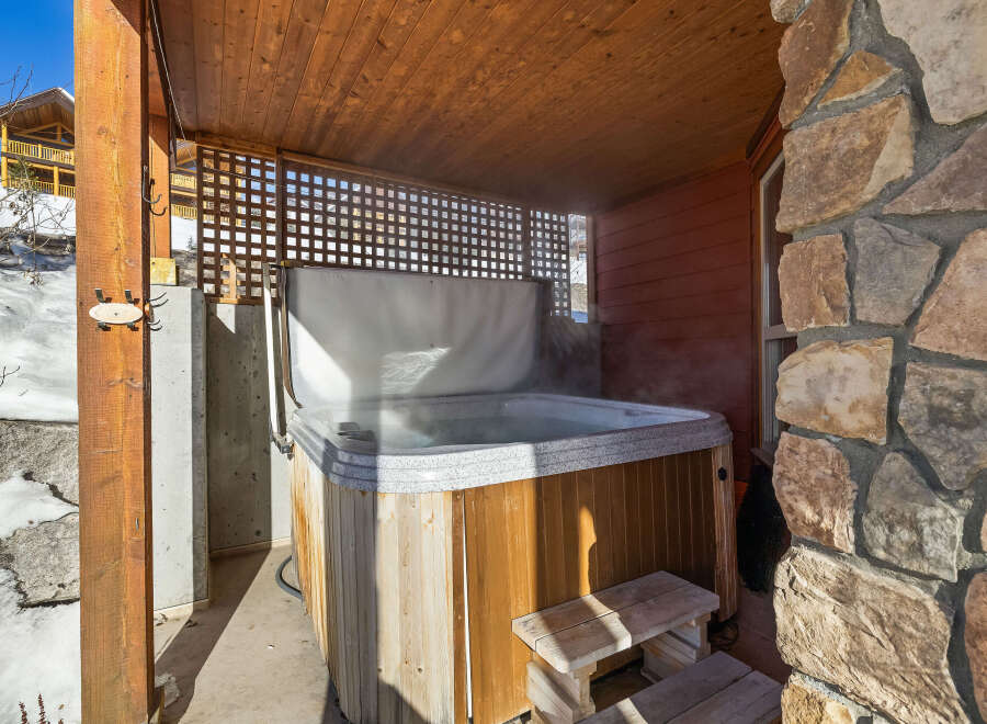Relax and unwind in this luxurious hot tub, perfect for enjoying the beautiful mountain views.