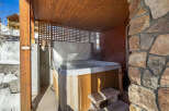 Relax and unwind in this luxurious hot tub, perfect for enjoying the beautiful mountain views.