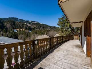 Enjoy breathtaking mountain views from this charming balcony.