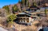 Discover a stunning chalet nestled in a picturesque mountain setting.